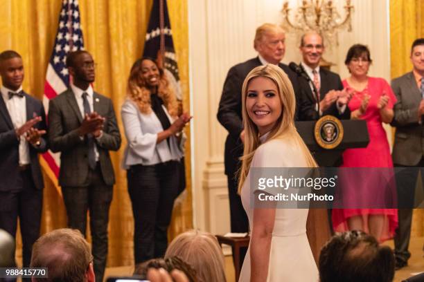 Ivanka Trump, daughter and assistant to U.S. President Donald Trump, stands as she's acknowledged by President Trump, during his event celebrating...