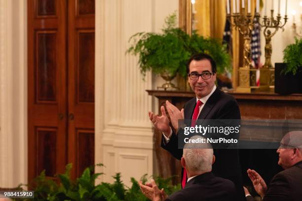 President Donald Trump acknowledges U.S. Treasury Secretary Steven Mnuchin, during his event celebrating the Republican tax cut plan in the East Room...