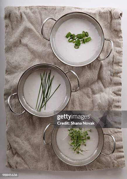fresh herbs in soup on a linen towel. - shana novak stockfoto's en -beelden