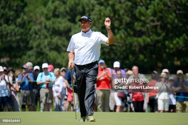 Fred Couples waves to the crowd after making a birdie putt on the first hole during round three of the U.S. Senior Open Championship at The Broadmoor...