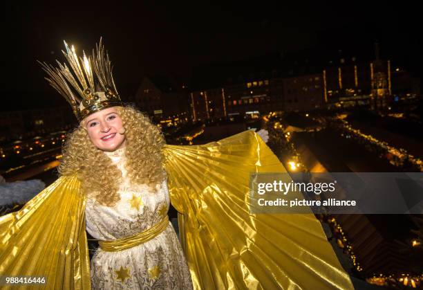 This year's Nuremberg "Christkind", Rebecca Ammon, spreads her wings after officially opening the Nuremberg Christmas market with a festive prologue...