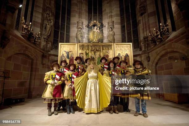 This year's Nuremberg "Christkind", Rebecca Ammon , stands beside a brass ensemble in the Lady's Church in Nuremberg, Germany, 01 December 2017....