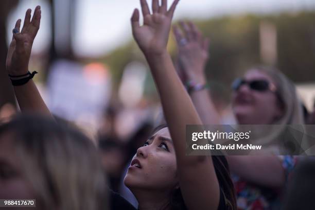 People call out words of encouragement to detainees held inside the Metropolitan Detention Center after marching to decry Trump administration...