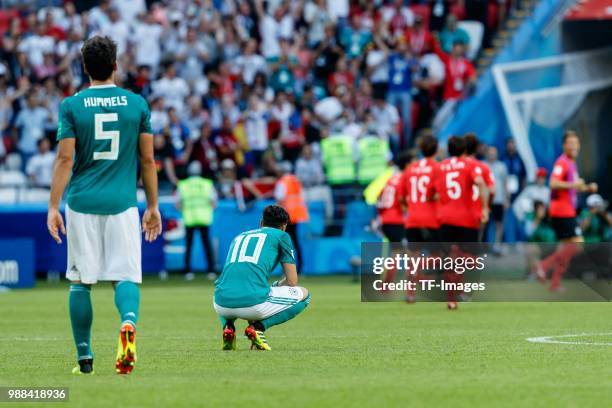 Mats Hummels of Germany and Mesut Oezil of Germany look dejected during the 2018 FIFA World Cup Russia group F match between Korea Republic and...