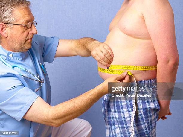 senior doctor measuring 12 year old obese boy - childhood obesity stock pictures, royalty-free photos & images
