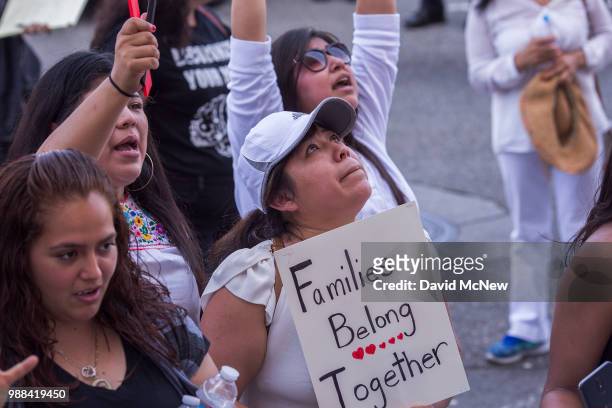 People demonstrate and call out words of encouragement to detainees held inside the Metropolitan Detention Center after marching to decry Trump...