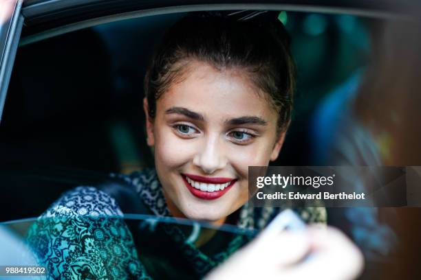 Taylor Hill is seen, during the Miu Miu Cruise Collection show, outside the Hotel Regina, in Paris, on June 30, 2018 in Paris, France.