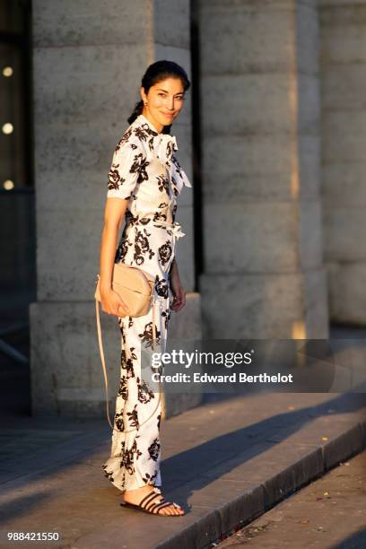 Caroline Issa wears a white dress with black floral prints, outside the Miu Miu Cruise Collection show, outside the Hotel Regina, in Paris, on June...