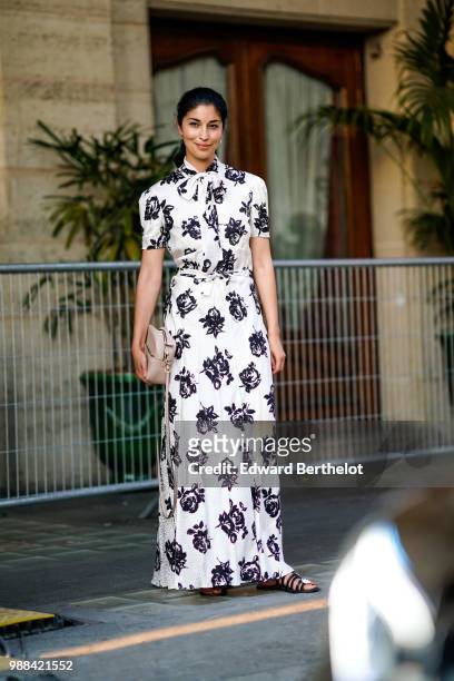 Caroline Issa wears a white dress with black floral prints, outside the Miu Miu Cruise Collection show, outside the Hotel Regina, in Paris, on June...