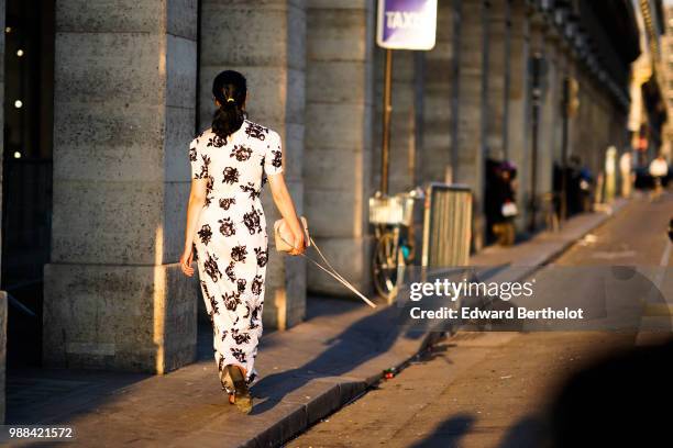 Caroline Issa wears a white dress with black floral prints, outside the Miu Miu Cruise Collection show, outside the Hotel Regina, in Paris, on June...