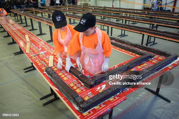 Pupils at the Philipp Reis school cut pieces of the giant "hedgehog slice" in a gymnasium for individual sale during an attempt at a world record in...