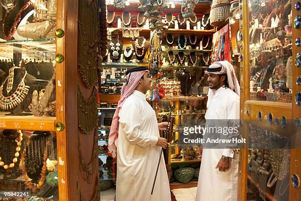 two arab men, galibeya, keffia head dress  - souq waqif fotografías e imágenes de stock