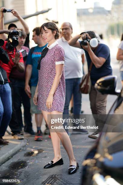 Ana de Armas wears a pink floral print dress, outside the Miu Miu Cruise Collection show, outside the Hotel Regina, in Paris, on June 30, 2018 in...