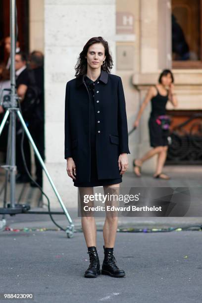 Aymeline Valade wears a black coat, black shoes, outside the Miu Miu Cruise Collection show, outside the Hotel Regina, in Paris, on June 30, 2018 in...