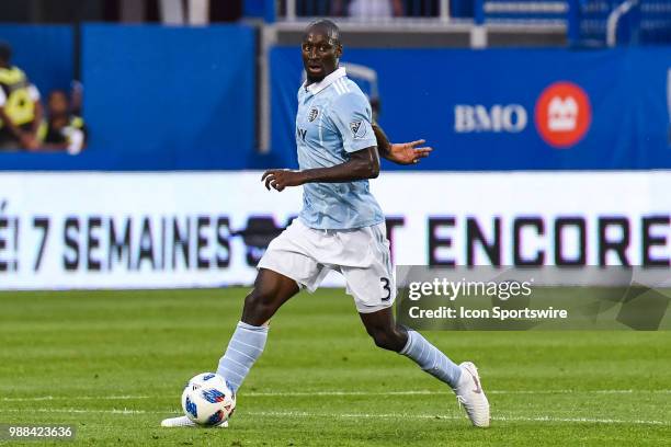 Sporting Kansas City defender Ike Opara runs with the ball while looking on his left during the Sporting Kansas City versus the Montreal Impact game...