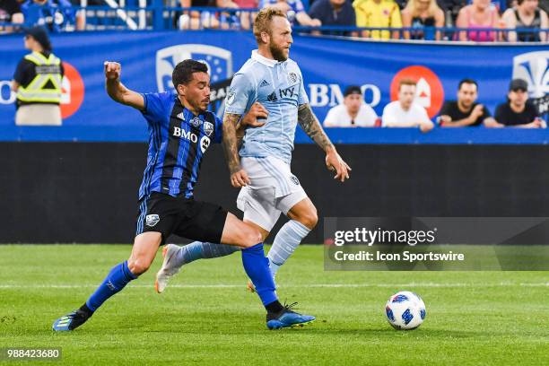 Montreal Impact defender Daniel Lovitz collides with Sporting Kansas City forward Johnny Russell during the Sporting Kansas City versus the Montreal...