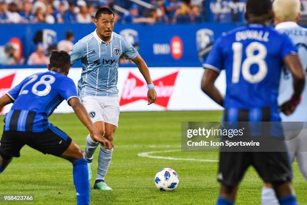 Sporting Kansas City midfielder Roger Espinoza looks for a pass target during the Sporting Kansas City versus the Montreal Impact game on June 30 at...