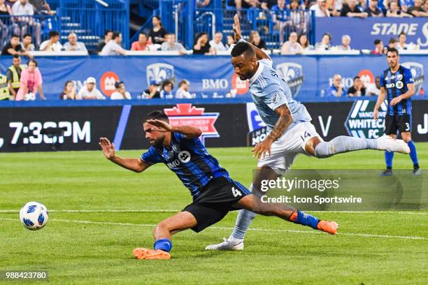 Montreal Impact defender Rudy Camacho falls on the ground after stopping a shot from Sporting Kansas City forward Khiry Shelton during the Sporting...