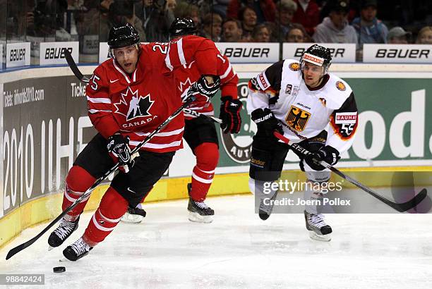 Felix Schuetz of Germany challenges Rich Peverley of Canada during the pre IIHF World Championship match between Germany and Canada at the O2 World...