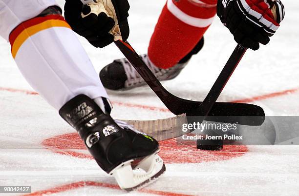 Two players battle for the puck during the pre IIHF World Championship match between Germany and Canada at the O2 World Hamburg on May 4, 2010 in...