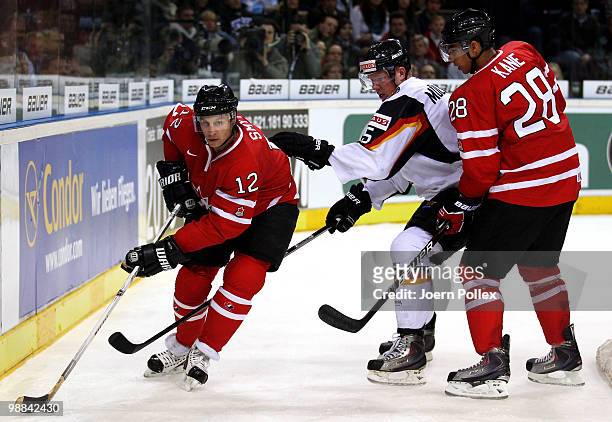Marcel Mueller of Germany challenges Ryan Smyth of Canada next to Evander Kane of Canada during the pre IIHF World Championship match between Germany...
