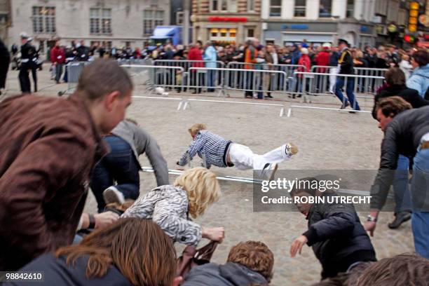 People run in a mass panick amid a rumour at the Remembrance Day on the Dam in Amsterdam, on May 4, 2010. Several man, also children, were carried...