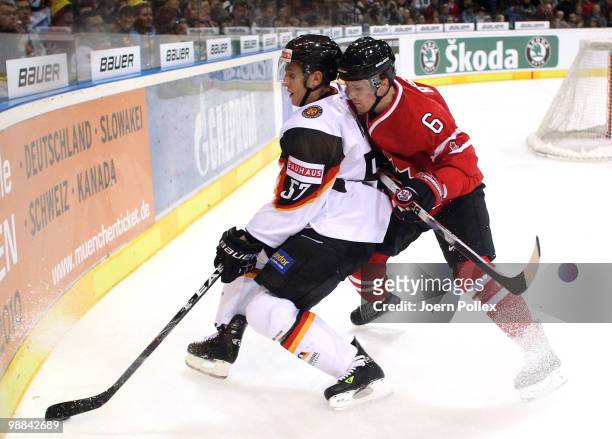 Kris Russell of Canada challenges Marcel Goc of Germany during the pre IIHF World Championship match between Germany and Canada at the O2 World...