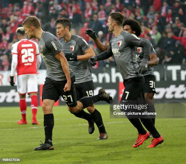 Augsburg's Alfred Finnbogason celebrates his 2-0 goal with team mates Marcel Heller, Ja-Cheol Koo, Paul Verhaegh and Francisco da Silva Caiuby during...