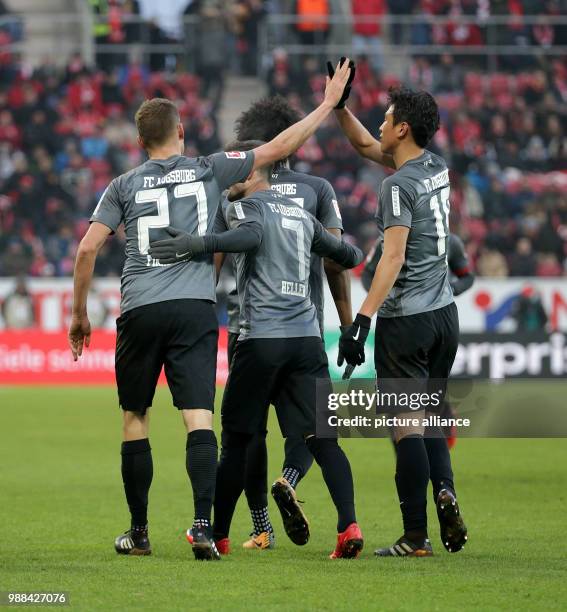 Augsburg's Alfred Finnbogason celebrates his 2-0 goal with team mates Marcel Heller, Ja-Cheol Koo, Paul Verhaegh and Francisco da Silva Caiuby during...