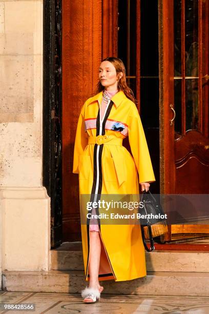 Audrey Marnay wears a yellow coat and walks the runway , outside the Miu Miu Cruise Collection show, outside the Hotel Regina, in Paris, on June 30,...