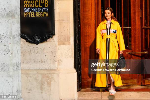 Audrey Marnay wears a yellow coat and walks the runway , outside the Miu Miu Cruise Collection show, outside the Hotel Regina, in Paris, on June 30,...