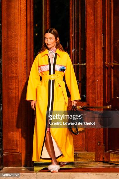 Audrey Marnay wears a yellow coat and walks the runway , outside the Miu Miu Cruise Collection show, outside the Hotel Regina, in Paris, on June 30,...