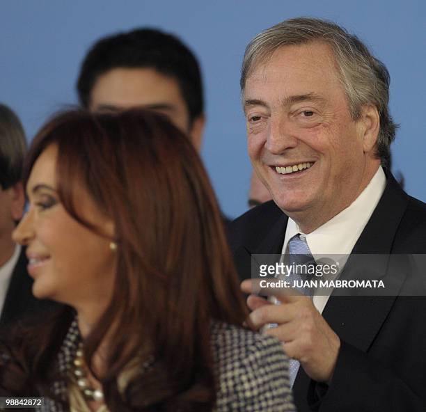 Argentine former President Nestor Kirchner , standing behind his wife Argentine President Cristina Fernandez de Kirchner, smiles before being elected...