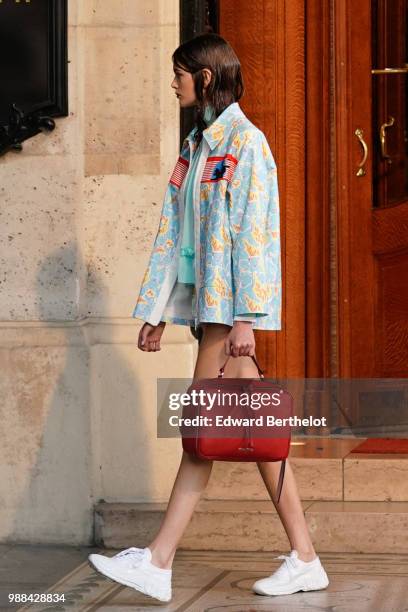 Model Kaia Gerber holds a red bag, outside the Miu Miu Cruise Collection show, outside the Hotel Regina, in Paris, on June 30, 2018 in Paris, France.