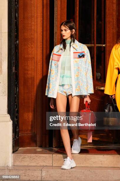 Model Kaia Gerber holds a red bag, outside the Miu Miu Cruise Collection show, outside the Hotel Regina, in Paris, on June 30, 2018 in Paris, France.