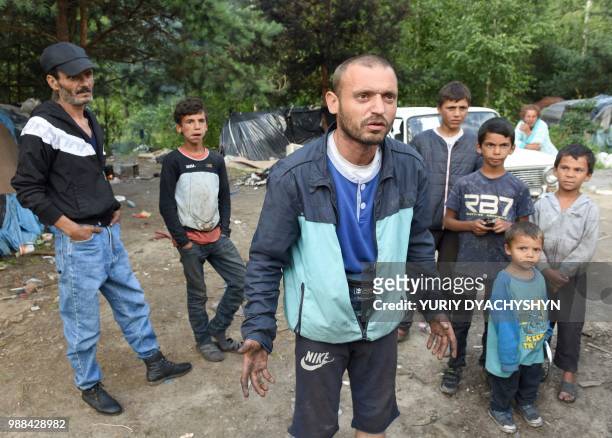 Misha speaks to an AFP journalist on June 25, 2018 in a Roma camp on the outskirts of Lviv which is hidden in the forest on the other side of the...