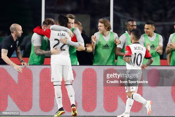 United midfielder Yamil Asad celebrates his second goal of the match with the subs during a match between the New England Revolution and DC United on...