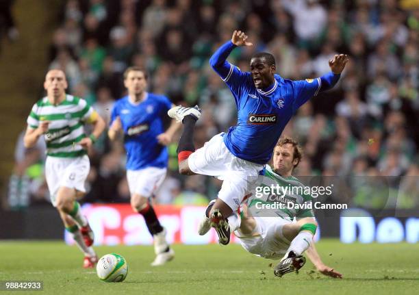 Maurice Edu of Rangers is tackled by Andreas Hinkel of Celtic during the Clydesdale Bank Scottish Premier League match between Celtic and Rangers at...