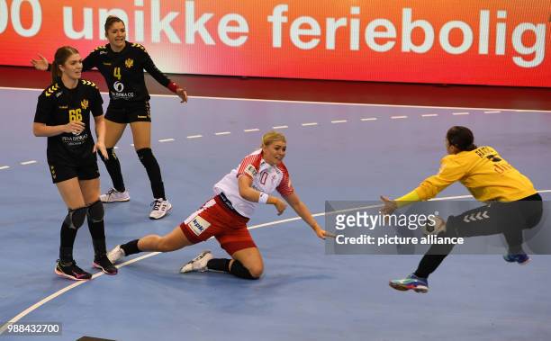 Denmark's Kathrin Heindahl is denied by Montenegro goalie Marina Rajcic, as Ema Ramusovic and Jovanka Radicevic of Montenegro look on, during the...