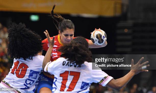 Spain's Almudena Rodriguez in action against Angola's Albertina Cruz Kassoma and Dalva Judith Perez during the women's handball world championships...