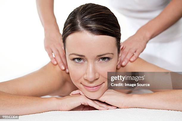 woman having a massage - massage table white background stock pictures, royalty-free photos & images