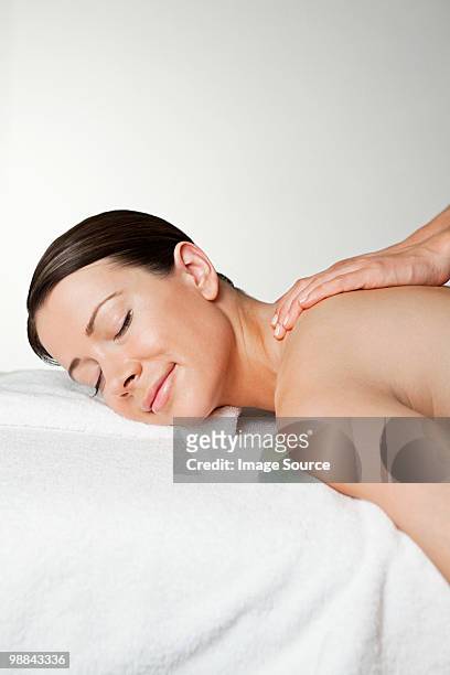 woman having a massage - massage table white background stock pictures, royalty-free photos & images