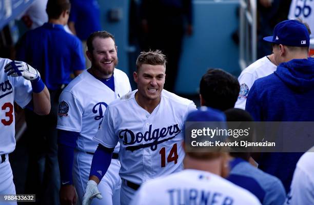 Enrique Hernandez of the Los Angeles Dodgers celebrates in the dugout after hitting a one run home run to break up a complete game by starting...