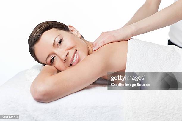 woman having a massage - massage table white background stock pictures, royalty-free photos & images