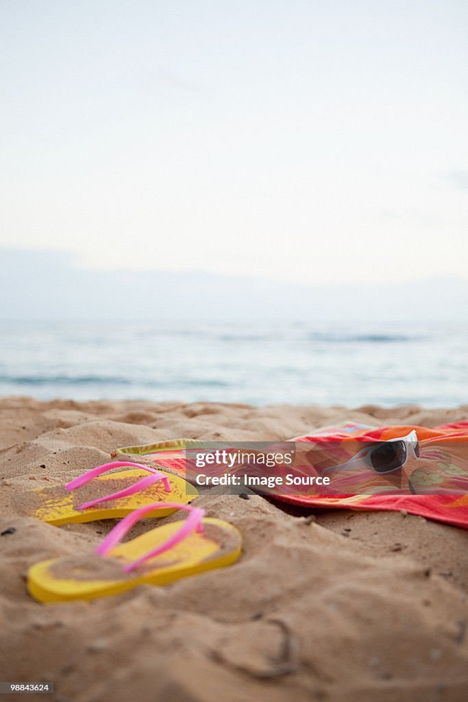 Flips flops and towel on beach