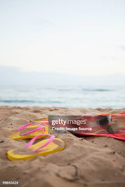 flips flops and towel on beach - strandfilt bildbanksfoton och bilder