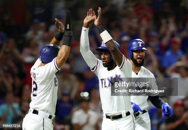 Rougned Odor of the Texas Rangers, Jurickson Profar of the Texas Rangers, and Nomar Mazara of the Texas Rangers celebrate after scoring on a double...