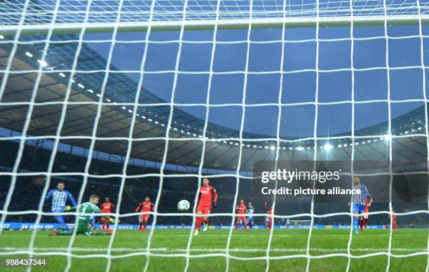 Berlin's Davie Selke scoring the opening goal against Eintracht goalkeeper Lukas Hradecky during the German Bundesliga soccer match between Hertha...