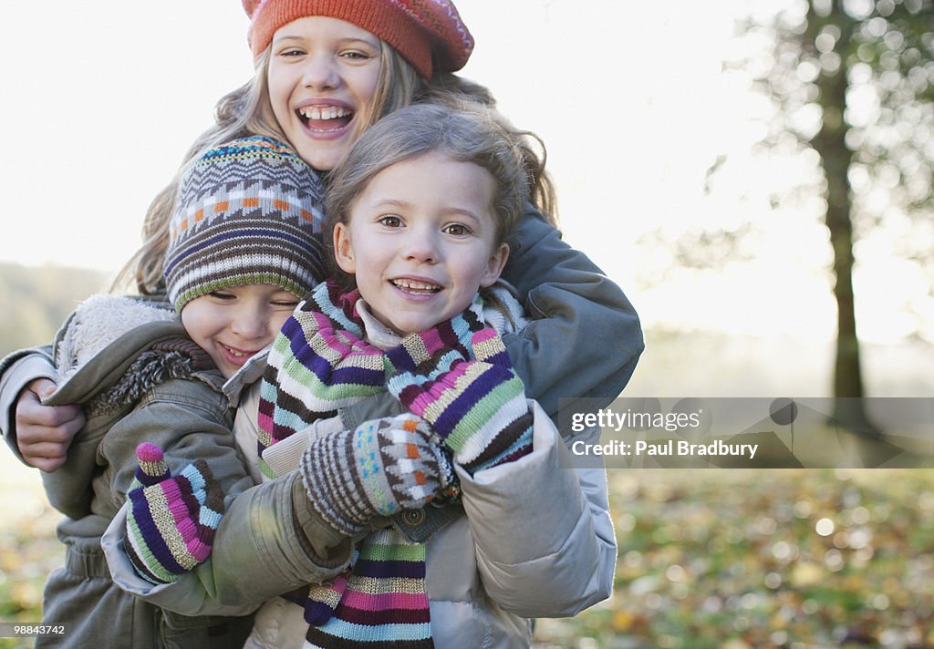 Playful children smiling outdoors in autumn