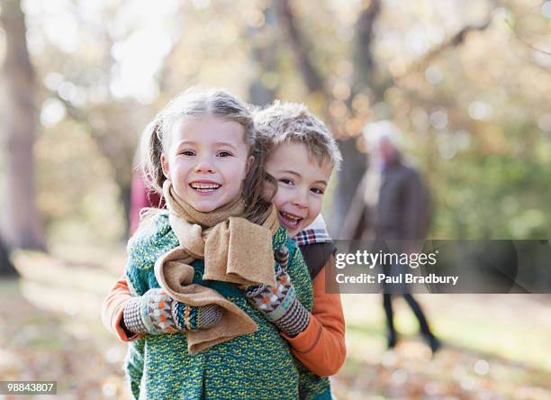 brother and sister hugging outdoors - sister stock pictures, royalty-free photos & images